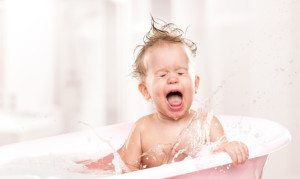 happy funny baby laughing and bathed in bath