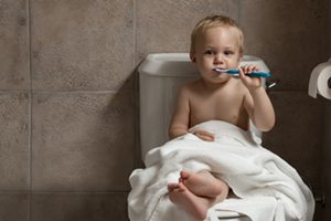 Toddler brushing his teeth after bath